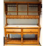 A pine double sided kitchen dresser/worktable with marble top with shelf and spice drawer back,