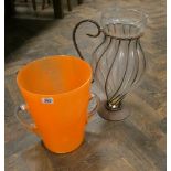 A large orange glass 2 handled vase and a large vase or jug in metal frame