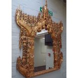 A very large Thai wall mirror in a decorative gold leaf & mirrored and coloured stone frame 70"