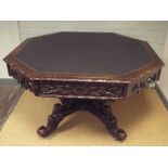 A Victorian carved oak octagonal library or centre table fitted 4 drawers standing on quadruple