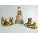 Three Hummel figurines of Virgin Mary and infant Jesus and two other nativity style scenes