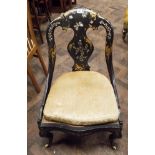 A Victorian black lacquered gilt and mother of pearl decorated occasional chair with cane panelled