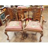 A pair of Chippendale style mahogany elbow chairs on cabriole style legs with tapestry upholstered