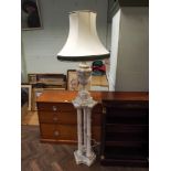 A large urn shaped white grained marble table lamp with cream shade