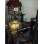 An old tilley lamp, flat irons, shoe lasts,