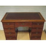 Edwardian mahogany knee hole writing desk fitted nine drawers with red leather tooled top,