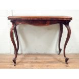 Victorian rosewood folding top card table standing on cabriole legs,