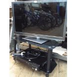 A Panasonic Viera 32" slim line LED television with Freeview etc and other apps on a 2 tier smoked