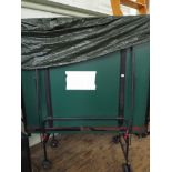 A Full size fold up table tennis table with net etc on wheels with cover