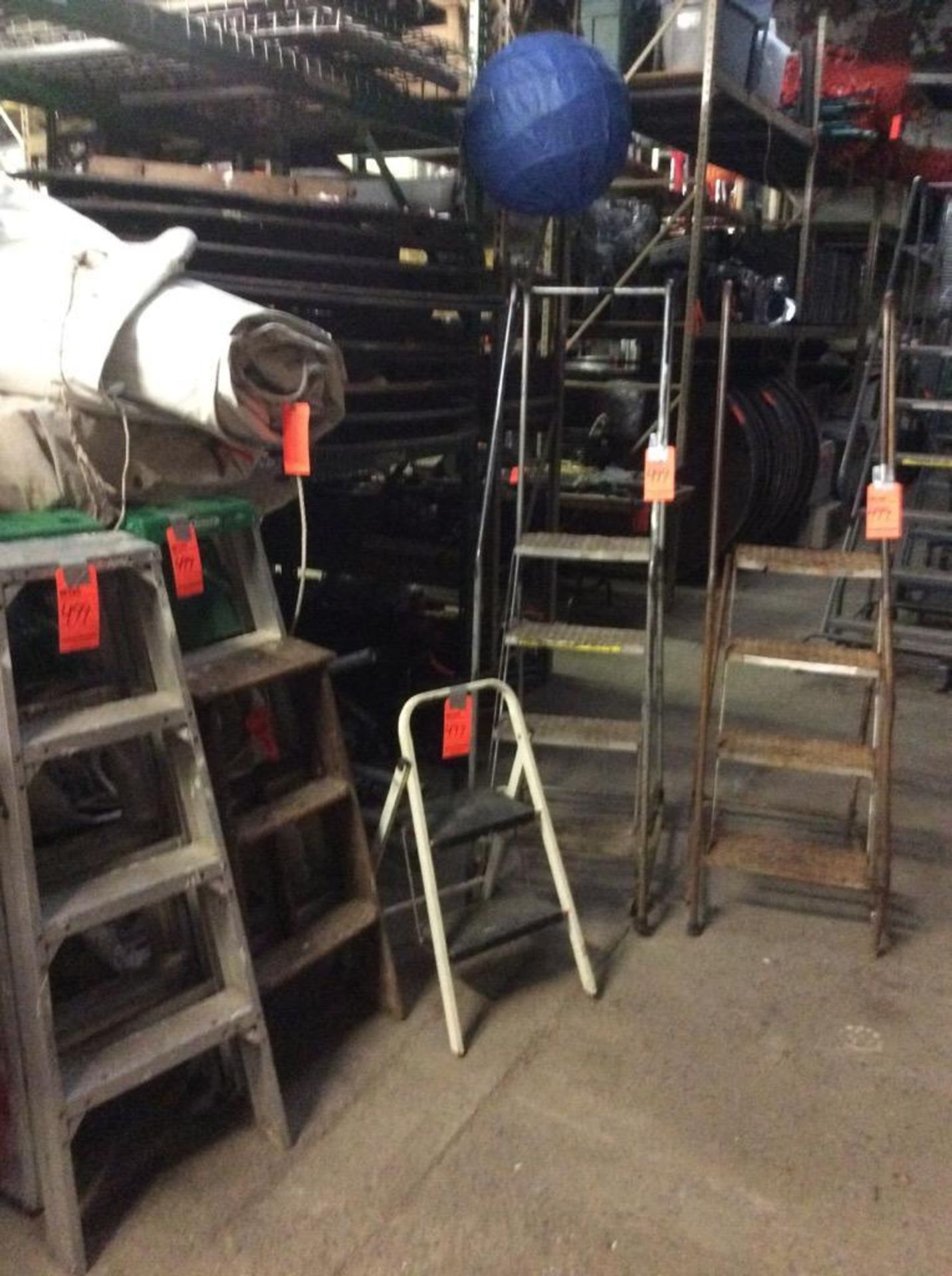 Lot includes (2) 4 step rolling stock ladders with 38" standing height, (3) 4' aluminum stepladders