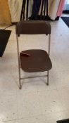 Lot of (75) brown folding chairs. In warehouse