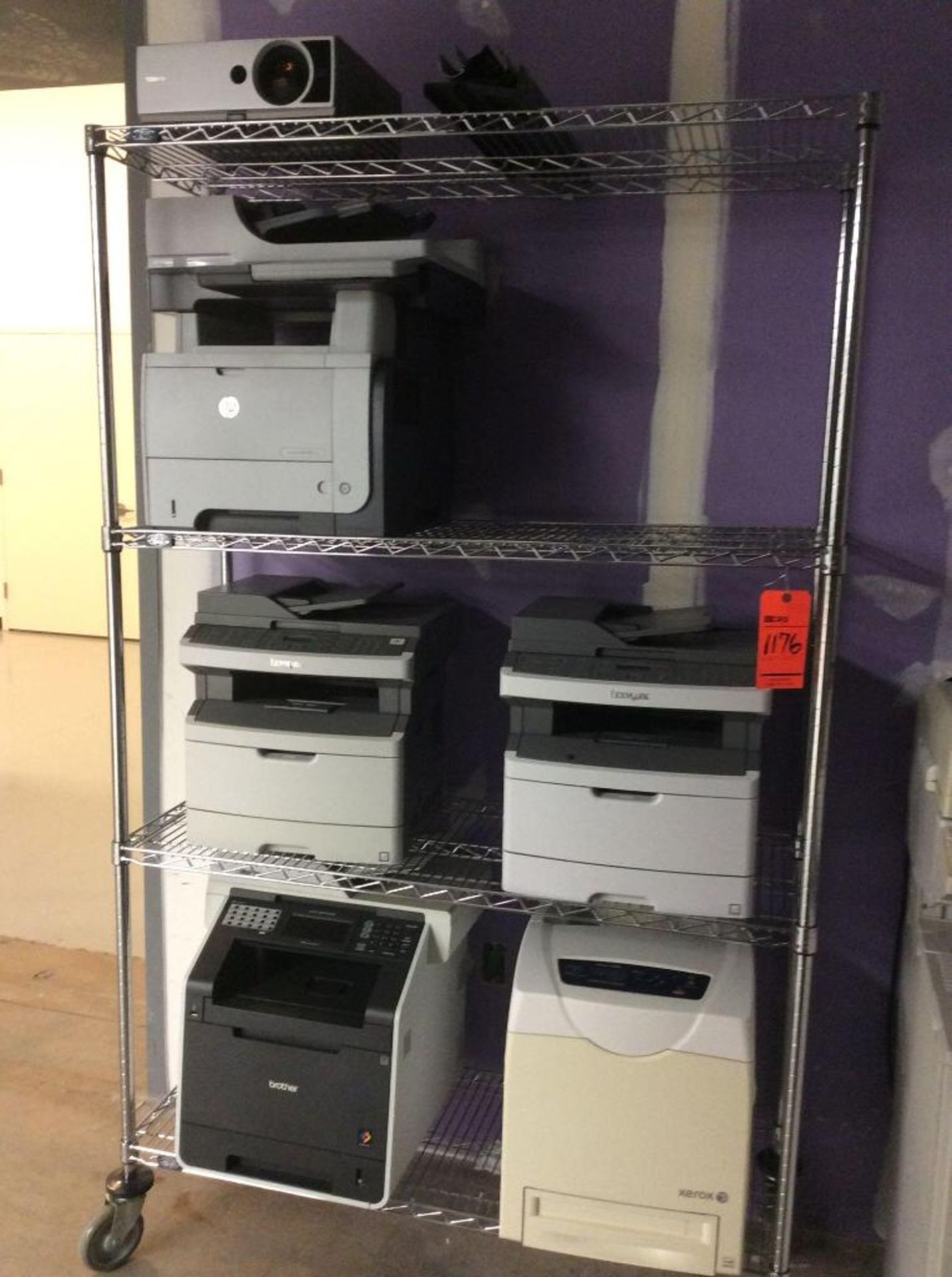 Large lot of assorted IT equipment contained on 7 rolling racks - includes monitors, printers, wires