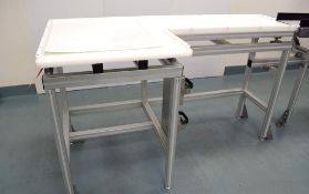 Manual Product Infeed Table. Aluminum frame, plastic table top.