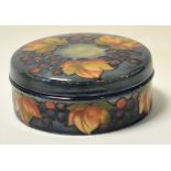 A Moorcroft pottery leaf and berry pattern jar and cover, 13.