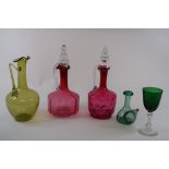 A cranberry glass decanter, 27 cm high, two others,