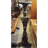 A carved giltwood torchere, decorated ac