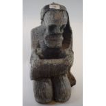 A carved wood figure, of a kneeling sain