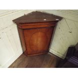 A satinwood hanging corner cupboard, 69.