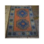 A Turkish rug, decorated a pair of centr