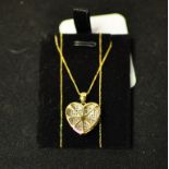A 9ct gold and pavé set diamond heart pe