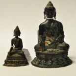 A small brass Buddha, 10.5 cm high, and