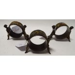 Three napkin rings, each supported by tw