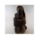 A carved wood figure, of a kneeling sain