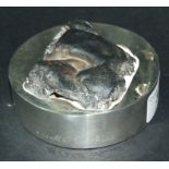 A silver desk weight, set a meteorite ty