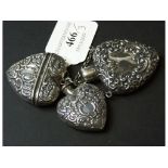 Three silver heart shaped containers