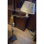 A folk art style standard lamp, on a wro