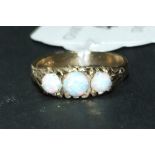 A 9ct gold ring, set three Gilson opals