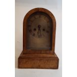 A mantel clock, the silver arched dial w