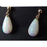 A pair of 9ct gold and teardrop opal ear