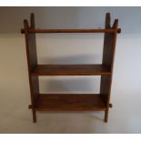 A set of pine painted wall shelves, with