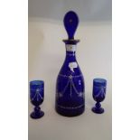 A blue glass decanter and stopper, with