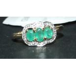 A 9ct gold, oval emerald and diamond rin