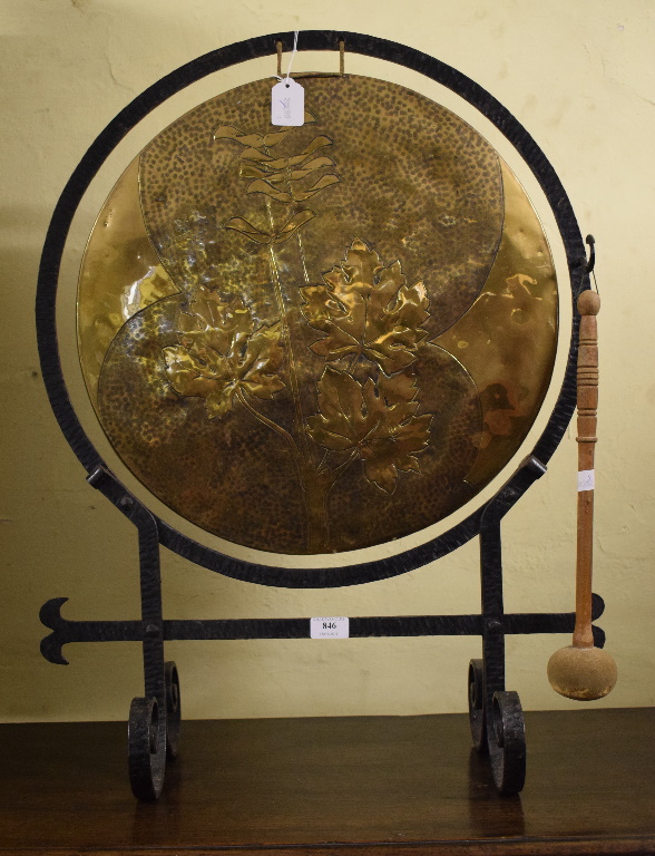 An Arts & Crafts brass dinner gong, on a