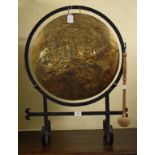 An Arts & Crafts brass dinner gong, on a