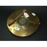 An Islamic gong, 25 cm diameter, with st