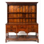 An oak and pine dresser, the moulded cornice above a two tier plate rack,