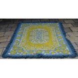 A Belgian quilted rug, decorated floral motifs on a white, blue and yellow ground, approx.