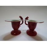 A pair of Chinese porcelain coral red sauce boats, with dragon handles,