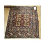 A small Baluch rug, a walnut wall mirror, a four fold screen,