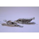 A plated letter clip, in the form of a pike head, and another,