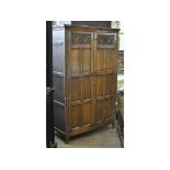 An 18th century style oak two door cupboard,