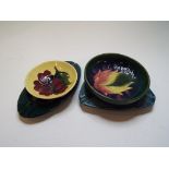 A Moorcroft pottery Clematis ashtray, 16 cm wide, a Hibiscus ashtray,