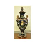 A pottery lamp, decorated putti,