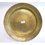 An Eastern brass bowl, with engraved scrolling decoration,