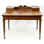 An Edwardian inlaid mahogany writing table, on tapering square legs,