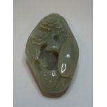 A carved jade pebble,